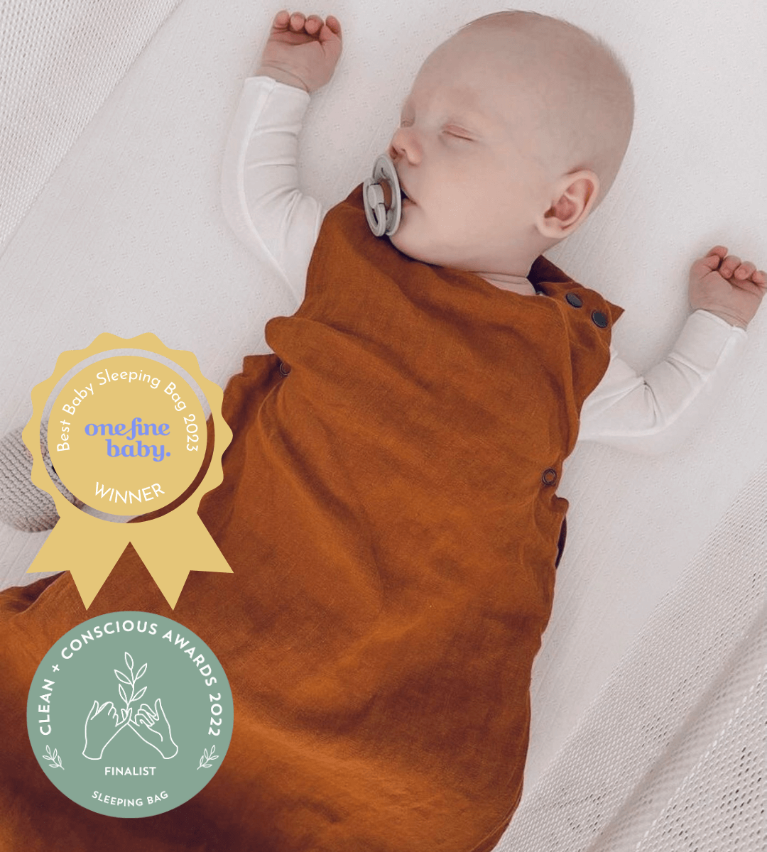 baby wearing bronze sleeping bag