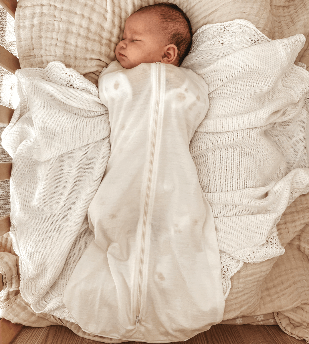 baby sleeping in swaddle sack