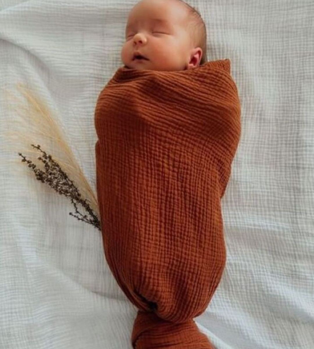 baby sleeping in swaddle wrap